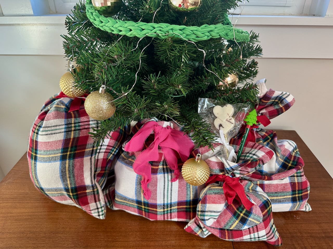 fabric gift bags under christmas tree